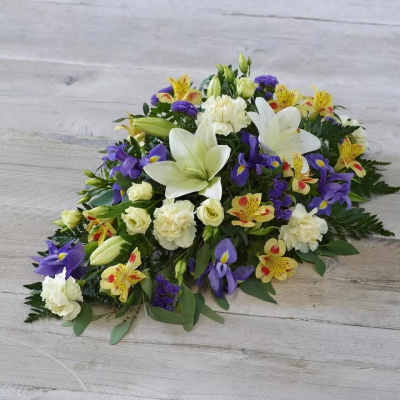 Lemon and Blue Spray - One of our most popular designs, this teardrop-shaped arrangement features stunning lemon and blue blooms including irises, lisianthus, and alstroemeria.

The image shows Large Size

Please note: for seasonal and other supply reasons, we may occasionally substitute some of the blooms shown in the image. We will always try to be true to the bouquet's colour coordination, style, and shape and guarantee to give you the full value paid. If you have any queries, please email or call us and we would be delighted to confirm availability and explain alternatives. See the 'Contact Us' section.