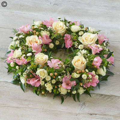 Soft Pastel Wreath - A beautiful pastel mix of soft pink, peach and cream. Featuring roses, chrysanthemums and delicate foliages.

The image shows Large Size

Please note: for seasonal and other supply reasons, we may occasionally substitute some of the blooms shown in the image. We will always try to be true to the bouquet's colour coordination, style, and shape and guarantee to give you the full value paid. If you have any queries, please email or call us and we would be delighted to confirm availability and explain alternatives. See the 'Contact Us' section.