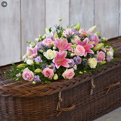 Rose and Eryngium Casket Spray - One of our most popular designs, this casket spray is a profusion of pastel blooms including pink and ivory roses and pink oriental lilies.

The image shows Large Size

Please note: for seasonal and other supply reasons, we may occasionally substitute some of the blooms shown in the image. We will always try to be true to the bouquet's colour coordination, style, and shape and guarantee to give you the full value paid. If you have any queries, please email or call us and we would be delighted to confirm availability and explain alternatives. See the 'Contact Us' section.