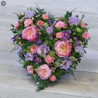 Cottage Garden Heart - Featuring stunning garden roses, delicate lilac lisianthus and scented rosemary, this heart tribute is full of beautiful tones.

Please Note: The image relates to the standard variant.