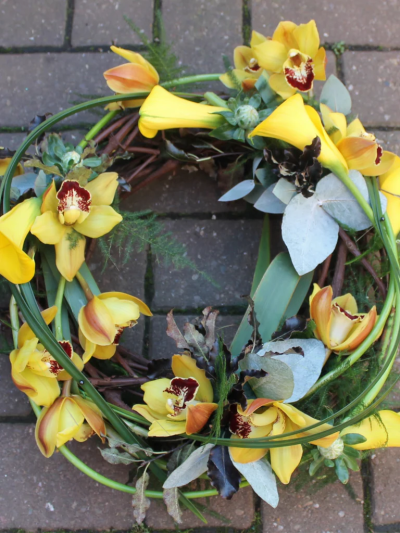 Woodland Wreath - Yellow calla lilies and cymbidium orchids are entwined with cornus stems, craspedia and asparagus fern around a circular willow frame to create this woodland wreath by Go Dutch Flowers.

The image shows Large Size

Please note: for seasonal and other supply reasons, we may occasionally substitute some of the blooms shown in the image. We will always try to be true to the bouquet's colour coordination, style, and shape and guarantee to give you the full value paid. If you have any queries, please email or call us and we would be delighted to confirm availability and explain alternatives. See the 'Contact Us' section.