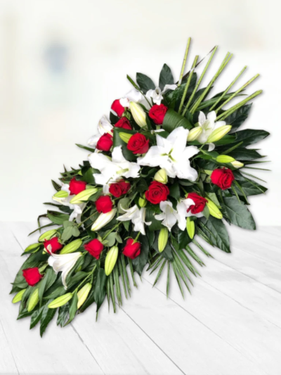 Rose and Lily Spray - Red & White - Aralia leaves and French ruscus are nestled amongst classic Oriental lilies and large-headed roses in this classic teardrop spray by Go Dutch Flowers.

Please note: for seasonal and other supply reasons, we may occasionally substitute some of the blooms shown in the image. We will always try to be true to the bouquet's colour coordination, style, and shape and guarantee to give you the full value paid. If you have any queries, please email or call us and we would be delighted to confirm availability and explain alternatives. See the 'Contact Us' section.