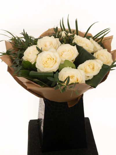 Snow White Roses - A fresh, hand-arranged bouquet of white roses hand-tied. Sophisticated and stunning, white roses create a gift of classic.

Delivered in water in our signature bag with flower food and full care instructions.