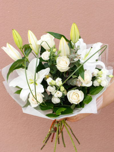 Dreamy White - This is a very elegant, contemporary hand-tied bouquet. Groups of crisp white flowers are beautifully framed by loops of steel grass. It’s simple in colour, but intricate in design, and the lilies give a sweet scent to the bouquet.

The image shows Large Size

Please note: for seasonal and other supply reasons, we may occasionally substitute some of the blooms shown in the image. We will always try to be true to the bouquet's colour coordination, style, and shape and guarantee to give you the full value paid. If you have any queries, please email or call us and we would be delighted to confirm availability and explain alternatives. See the 'Contact Us' section.