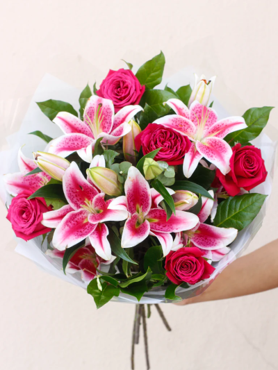 Pink Rose and Lily Hand-tied - This is a truly spectacular combination of large-headed roses and elegant oriental lilies. It’s a popular choice too - these flowers are firm favourites, and work so beautifully together. Simple, and very stylish, this hand-tied bouquet is a fabulous gift.

Featuring 5 pink large-headed roses with 2 pink oriental lilies, eucalyptus and salal leaves, hand-tied and presented in gift packaging.

The image shows Large Size

Please note: for seasonal and other supply reasons, we may occasionally substitute some of the blooms shown in the image. We will always try to be true to the bouquet's colour coordination, style, and shape and guarantee to give you the full value paid. If you have any queries, please email or call us and we would be delighted to confirm availability and explain alternatives. See the 'Contact Us' section.