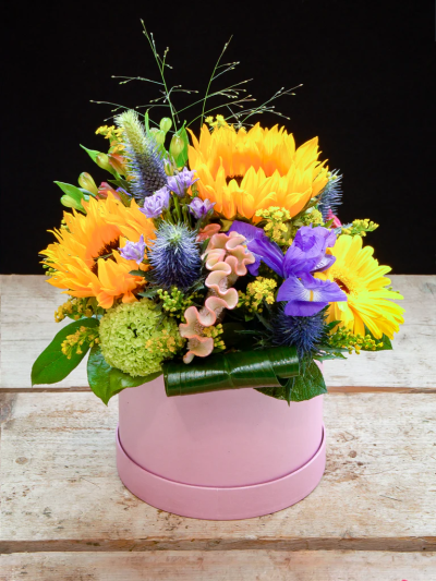 Sunny Flower Box - An energetic arrangement of luxurious flowers such as sunflowers, gerbera, blue iris, celosia, alstroemeria, thistle, solidago and greeneries. Made to impress in a stylish hatbox.


Please note: for seasonal and other supply reasons, we may occasionally substitute some of the blooms shown in the image. We will always try to be true to the bouquet's colour coordination, style, and shape and guarantee to give you the full value paid. If you have any queries, please email or call us and we would be delighted to confirm availability and explain alternatives. See the 'Contact Us' section.