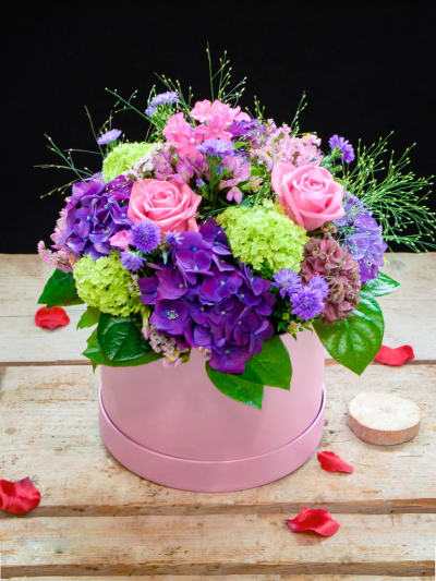Pink and Purple Hatbox - A vibrant arrangement of luxurious flowers in a pink & purple colourway. Made to impress in a stylish hatbox.

Please note: for seasonal and other supply reasons, we may occasionally substitute some of the blooms shown in the image. We will always try to be true to the bouquet's colour coordination, style, and shape and guarantee to give you the full value paid. If you have any queries, please email or call us and we would be delighted to confirm availability and explain alternatives. See the 'Contact Us' section.