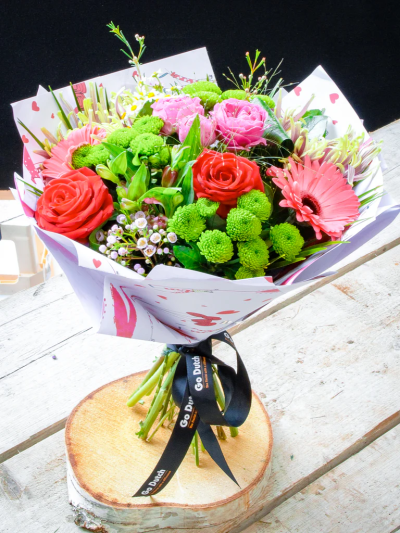 Charming Bouquet - Someone is going to love this gift! The kaleidoscope of vigorous colour ensures this striking hand-tied takes centre stage right away. With red roses, pink gerberas, blooms, maticari and santini chrysants finished with spray roses, waxflowers, alstroemeria and foliage. This is certainly the right choice of gift to make a lasting impression.

The image shows Large Size

Please note: for seasonal and other supply reasons, we may occasionally substitute some of the blooms shown in the image. We will always try to be true to the bouquet's colour coordination, style, and shape and guarantee to give you the full value paid. If you have any queries, please email or call us and we would be delighted to confirm availability and explain alternatives. See the 'Contact Us' section.