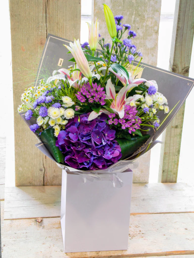 Pretty Alana Bouquet - A pretty collection of purple & lilac flowers skilfully arranged in a beautiful basket to send your message in a wonderful way.

Please note: for seasonal and other supply reasons, we may occasionally substitute some of the blooms shown in the image. We will always try to be true to the bouquet's colour coordination, style, and shape and guarantee to give you the full value paid. If you have any queries, please email or call us and we would be delighted to confirm availability and explain alternatives. See the 'Contact Us' section.