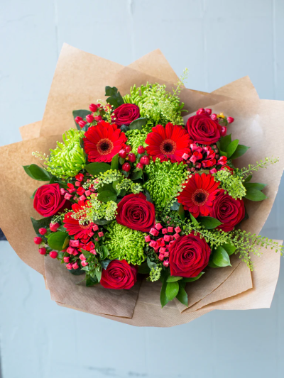 Emerald Kisses - This romantic bouquet is guaranteed to make someone feel very special.

Featuring large-headed Naomi roses with large green Chrysanthemum blooms, red germinis and berries hand-tied together with ruscus and thalaspi it is sure to impress. 

The image shows Large Size

Please note: for seasonal and other supply reasons, we may occasionally substitute some of the blooms shown in the image. We will always try to be true to the bouquet's colour coordination, style, and shape and guarantee to give you the full value paid. If you have any queries, please email or call us and we would be delighted to confirm availability and explain alternatives. See the 'Contact Us' section.