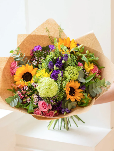 The Sunshine Hand-tied Bouquet - This beautifully designed hand-tied bouquet would make anybody happy! 

Featuring Viburnum, Lisianthus, Sunflower, Thalaspie, Spray rose, Alstro, Bouvardia with selected foliages.

The image shows Large Size

Please note: for seasonal and other supply reasons, we may occasionally substitute some of the blooms shown in the image. We will always try to be true to the bouquet's colour coordination, style, and shape and guarantee to give you the full value paid. If you have any queries, please email or call us and we would be delighted to confirm availability and explain alternatives. See the 'Contact Us' section.