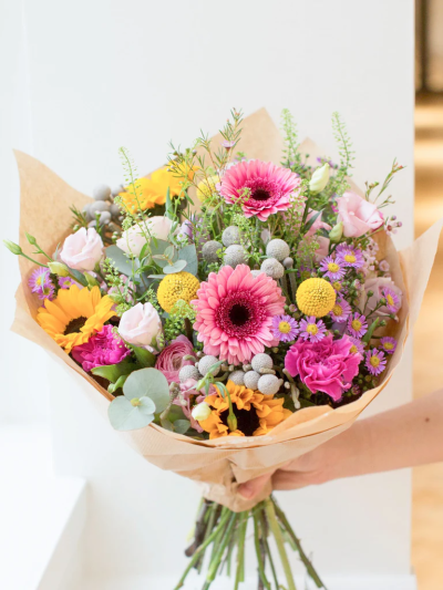 The Claddagh Bouquet - This beautifully designed hand-tied bouquet would make anybody happy! 

Featuring, Germini, Carnation, Lisianthus, Sunflower, Thalaspie, September, Crespedia, Brunai with selected foliages.

The image shows Large Size

Please note: for seasonal and other supply reasons, we may occasionally substitute some of the blooms shown in the image. We will always try to be true to the bouquet's colour coordination, style, and shape and guarantee to give you the full value paid. If you have any queries, please email or call us and we would be delighted to confirm availability and explain alternatives. See the 'Contact Us' section.