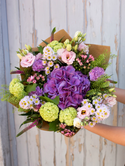 Purple Breeze - We’ve chosen luxurious purple hydrangeas, soft pinks, and greens in this sensational display. Beautifully presented with a balance of contrasting colours and textures, this glorious summer gift is ready to take pride of place on arrival.

The image shows Large Size

Please note: for seasonal and other supply reasons, we may occasionally substitute some of the blooms shown in the image. We will always try to be true to the bouquet's colour coordination, style, and shape and guarantee to give you the full value paid. If you have any queries, please email or call us and we would be delighted to confirm availability and explain alternatives. See the 'Contact Us' section.