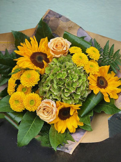 Under the Sun Bouquet - This beautifully designed hand-tied bouquet would make anybody happy! 
The image shows Large Size

Please note: for seasonal and other supply reasons, we may occasionally substitute some of the blooms shown in the image. We will always try to be true to the bouquet's colour coordination, style, and shape and guarantee to give you the full value paid. If you have any queries, please email or call us and we would be delighted to confirm availability and explain alternatives. See the 'Contact Us' section.