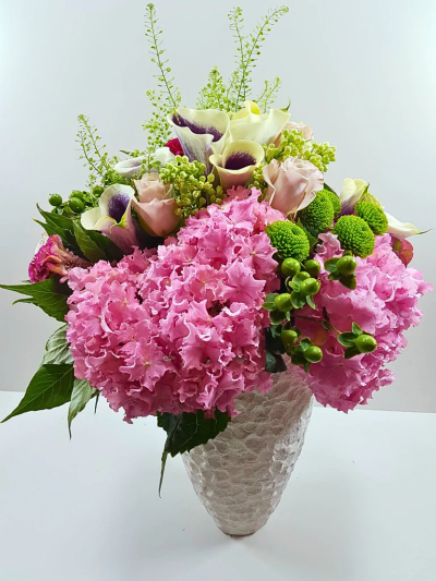 Victorian Romance Vase - A vibrant collection of fresh flowers which includes Hydrangeas and Callalily with a touch of spring. Delivered in a vase. Make it a happy occasion and show how much you care.

Please note: for seasonal and other supply reasons we may, from time to time, substitute some of the blooms shown in the image. We will always try to be true to the colour co-ordination, style and shape of the bouquet and will always guarantee to give you the full value paid. If you have any queries, please email or call us and we would be delighted to confirm availability and or explain alternatives. See 'contact us' section.